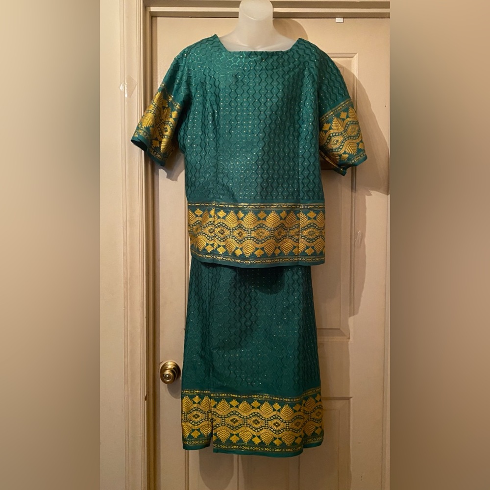 Green and gold African dress with matching hat and sash.